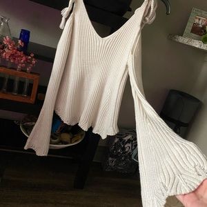 Knitted sweater with scalloped edges and rope ties on shoulder